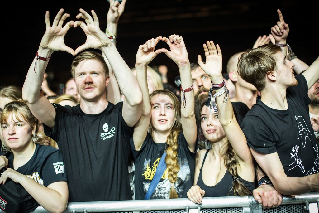 Festival-goers forming a heart with both hands