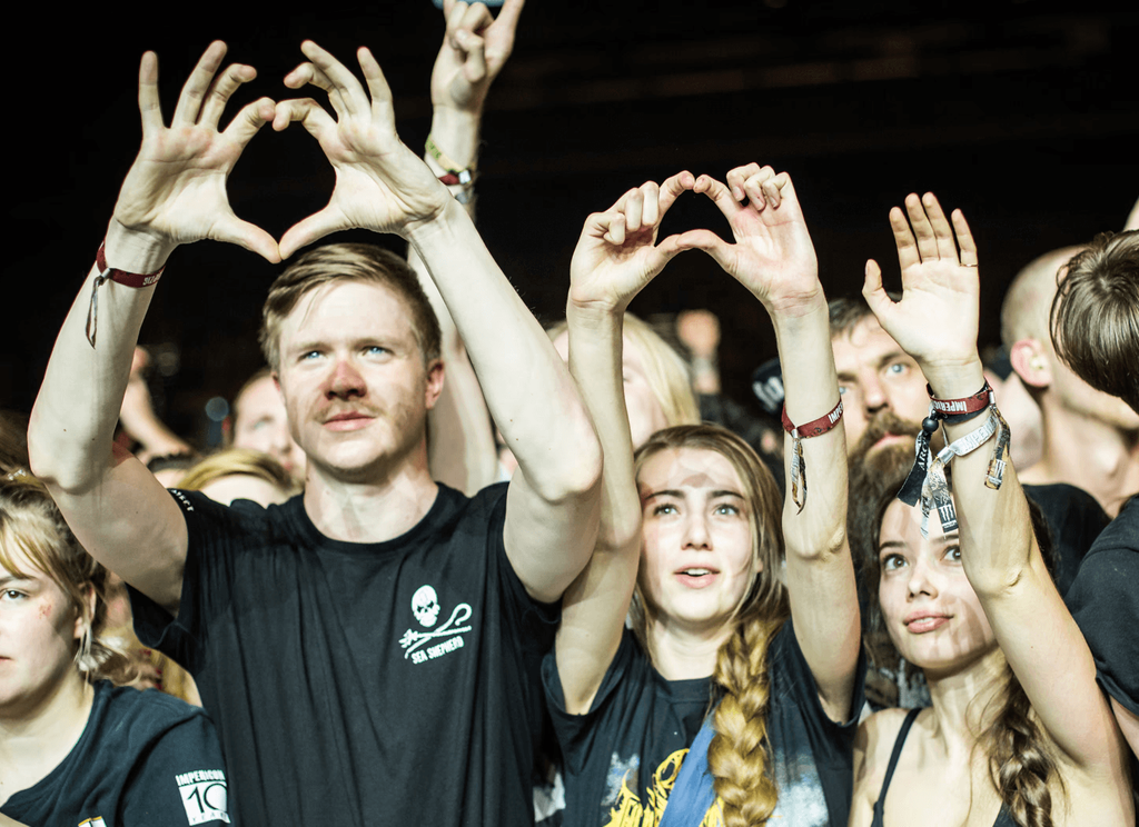 Festival visitors forming a heart with their hands