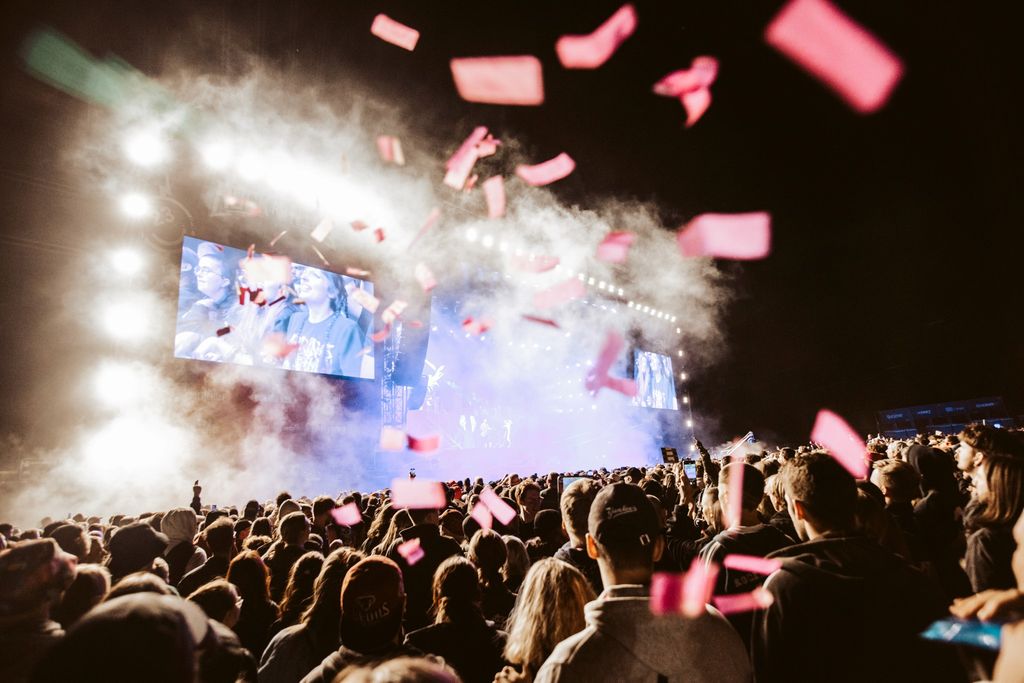 A view from the audience of a festival stage with lots of confetti