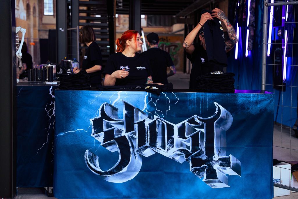 Sales staff are packing goods at a pop-up store for the band Ghost
