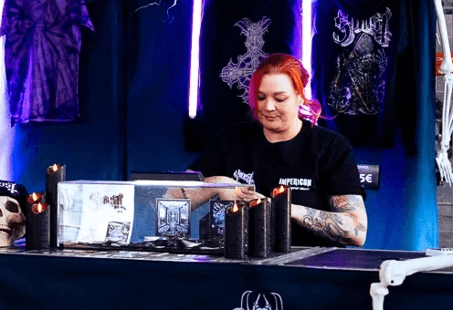 A sales associate at a pop-up store for the band Ghost