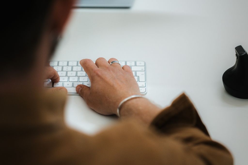A man is typing on a keyboard in the office